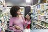 Young woman examining jar in shop