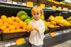 Small boy with fresh fruit in shop