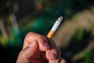Cigarette in hand outdoors